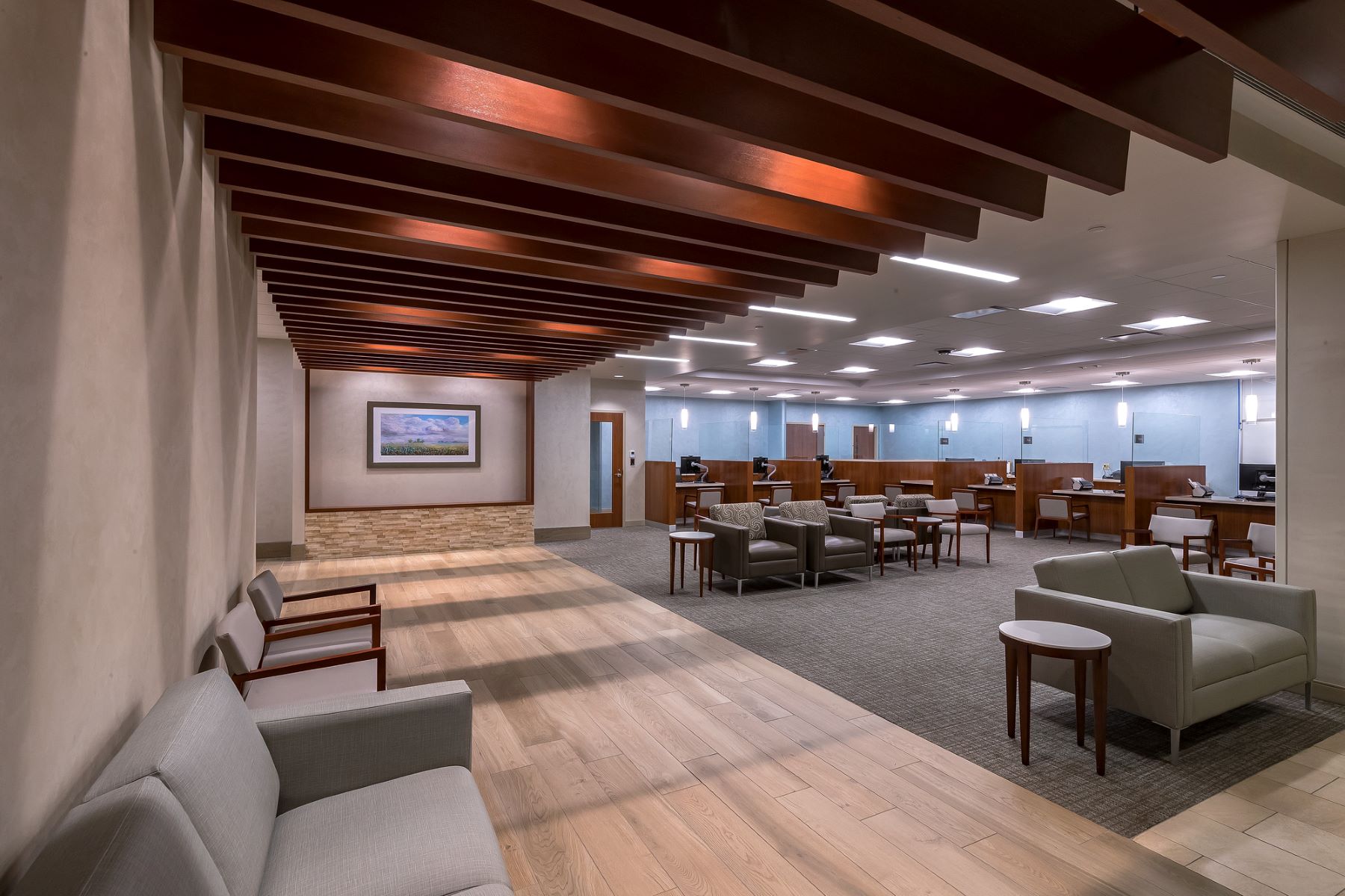 A waiting room with lots of chairs and overhead beams