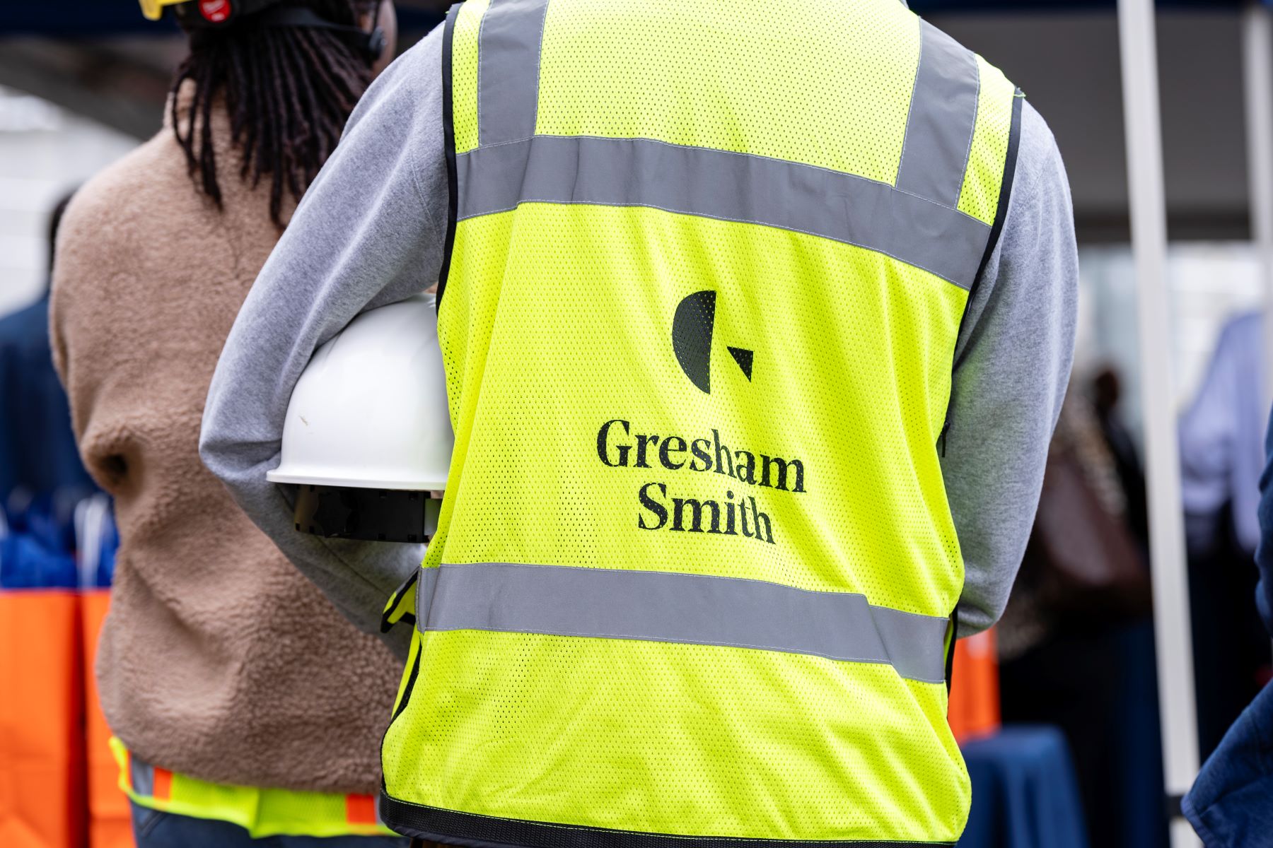 the back of a yellow construction vest with the Gresham Smith logo