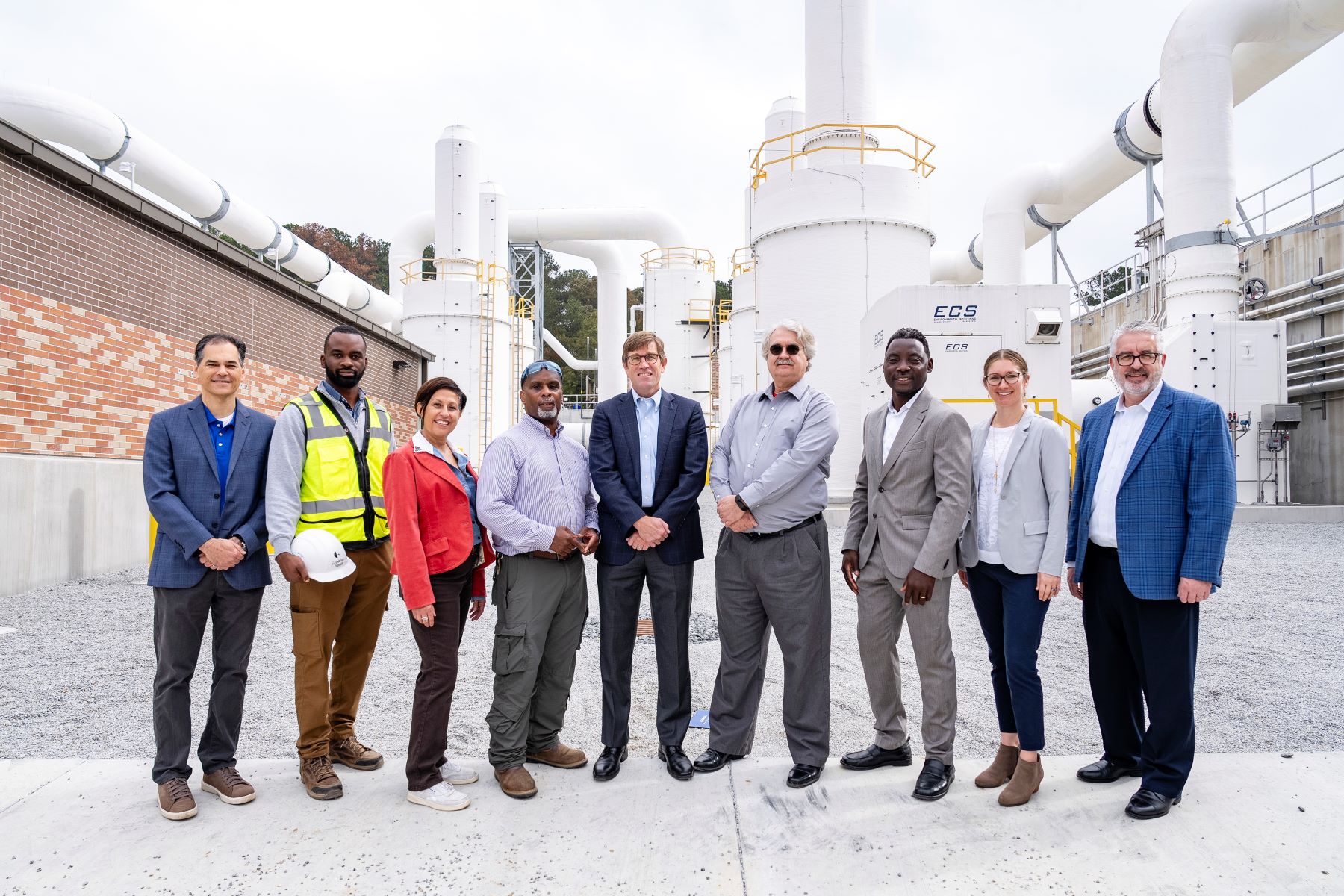 group of people standing together at a wastewater treatment plant