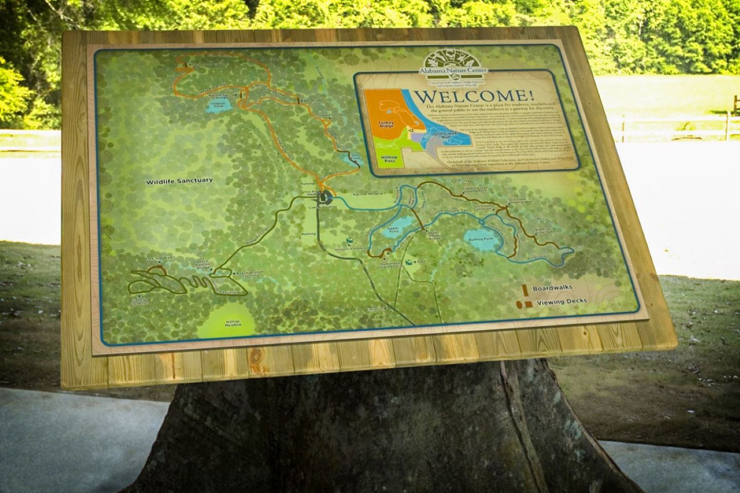 map of a nature center mounted on a large log