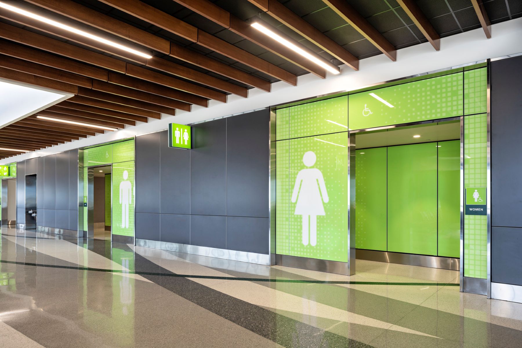 bright green entry portals to airport bathrooms