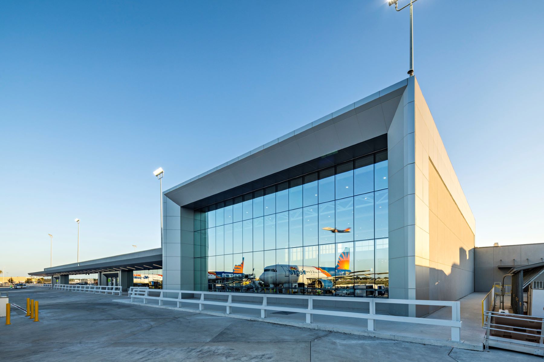 exterior of the new concourse at sarasota bradenton international airport featuring a large wall of windows